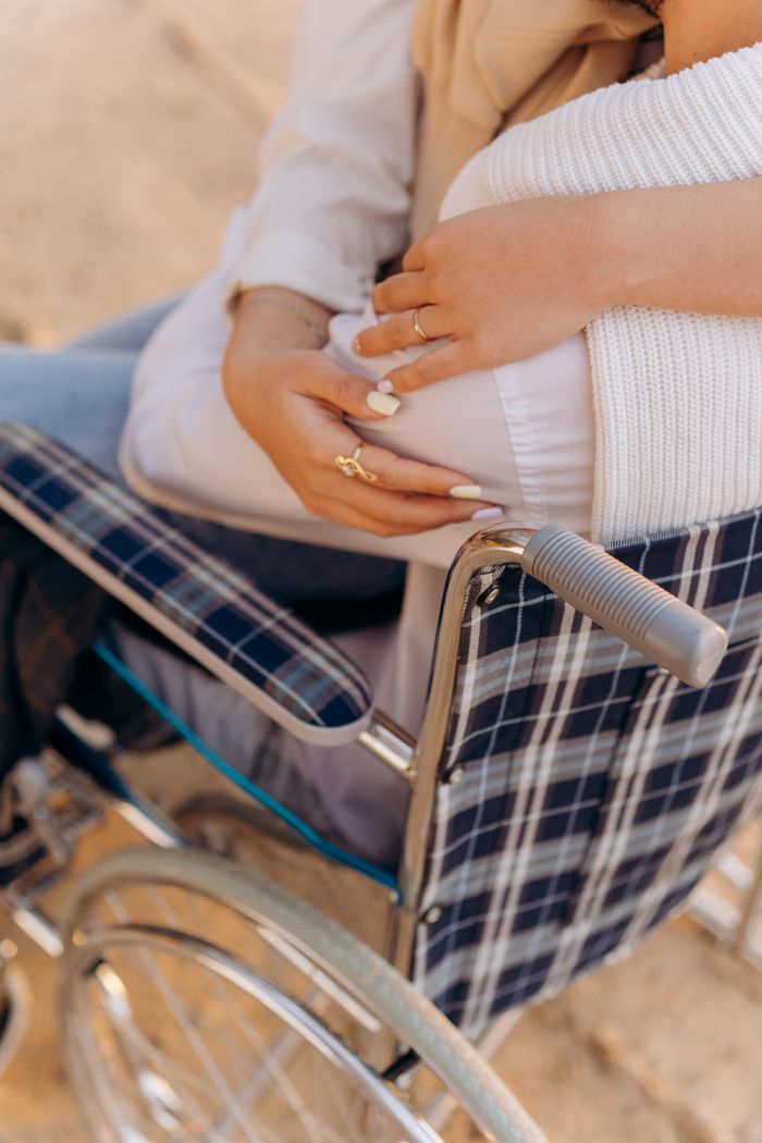 A comforting embrace captured in a wheelchair, symbolizing support and care.